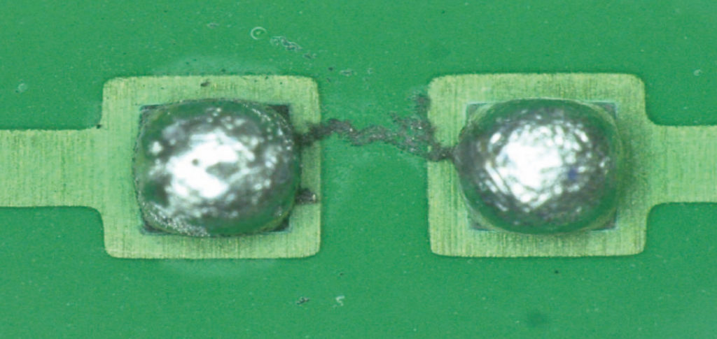 Electrochemical migration dendrite formation causing PCB short circuit