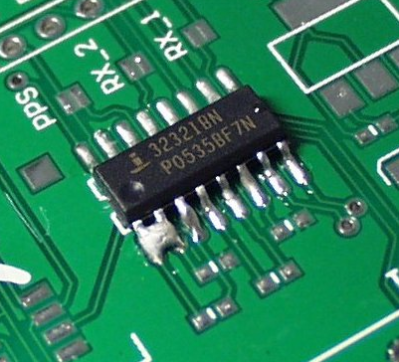 PCB solder bridge defect causing short circuit between IC pins